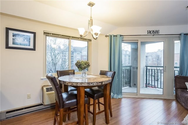 dining space with a wall mounted AC, vaulted ceiling, dark hardwood / wood-style flooring, and an inviting chandelier