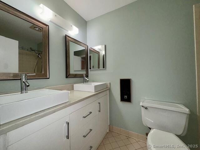 bathroom with toilet, tile patterned floors, and vanity