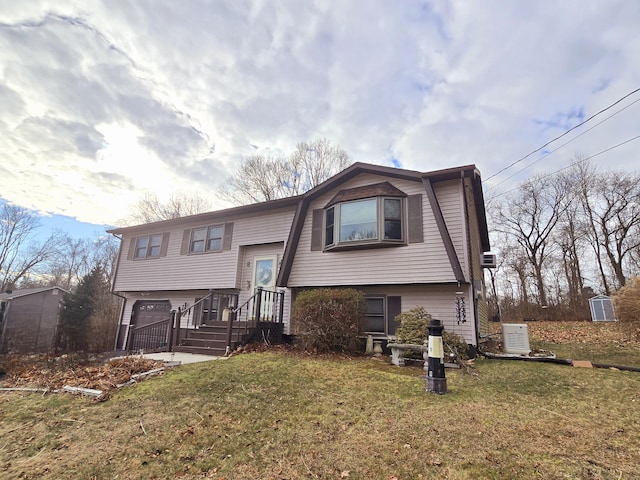 split foyer home featuring a garage and a front yard