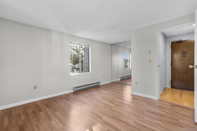 spare room featuring light hardwood / wood-style flooring and a baseboard radiator