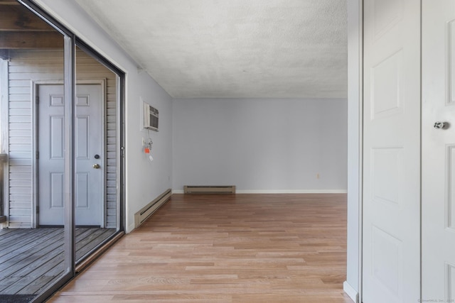 interior space featuring a wall unit AC and baseboard heating