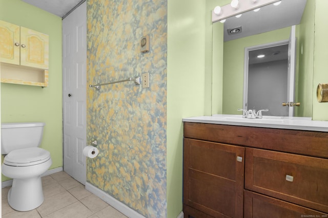 bathroom with toilet, tile patterned floors, and vanity