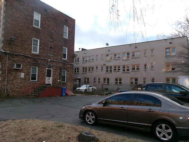 view of building exterior featuring a wall unit AC