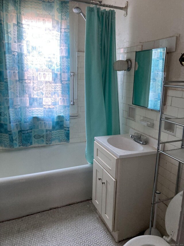 full bathroom with toilet, vanity, tile patterned floors, and shower / tub combo with curtain