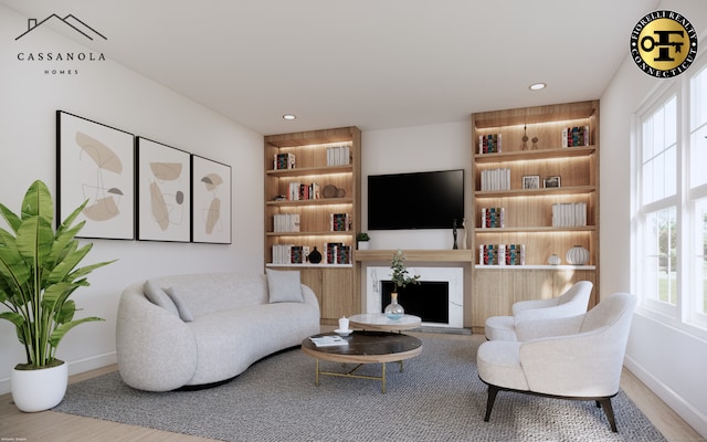 living room featuring built in features, recessed lighting, a fireplace with raised hearth, and baseboards