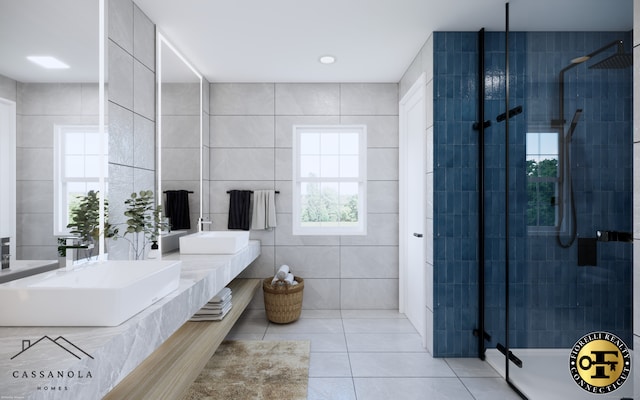 bathroom with a shower stall, tile walls, a sink, and tile patterned floors