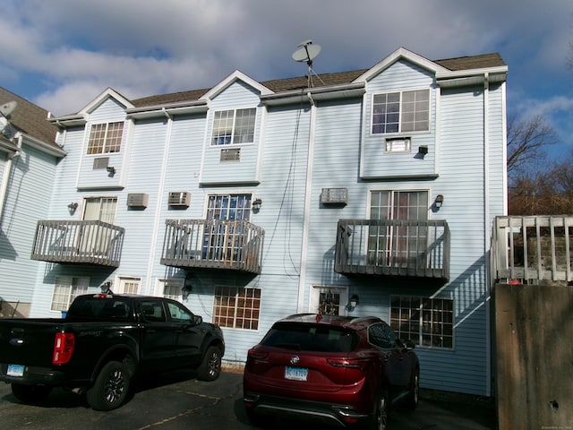 rear view of property featuring a balcony