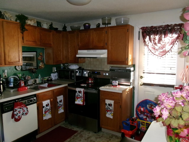 kitchen featuring range with electric stovetop, dishwasher, sink, and backsplash