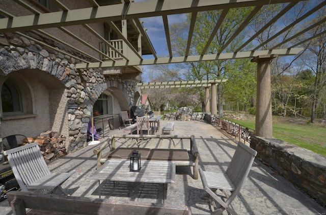 view of patio with outdoor dining area, exterior fireplace, and a pergola