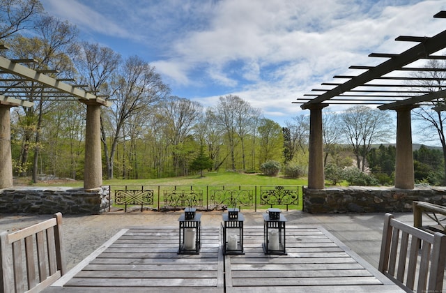 exterior space featuring a patio area, a yard, and a pergola