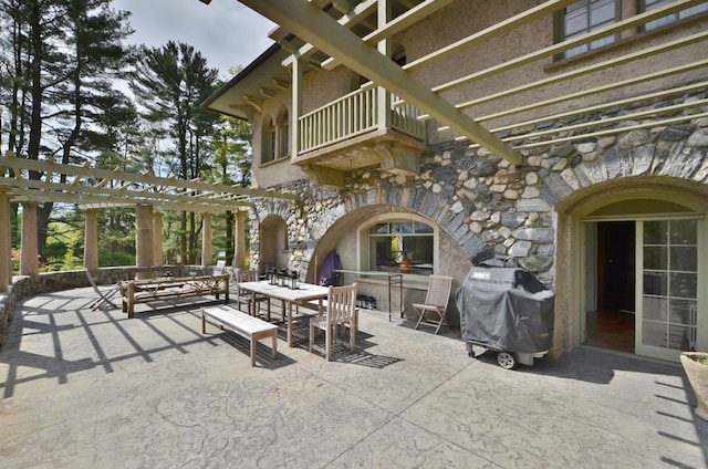 view of patio / terrace featuring outdoor dining space, grilling area, a balcony, and a pergola