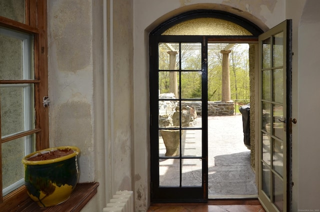 doorway featuring french doors and radiator heating unit