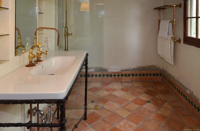 bathroom with a sink and tile patterned floors