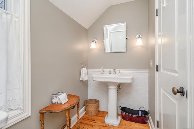 bathroom featuring lofted ceiling and hardwood / wood-style floors