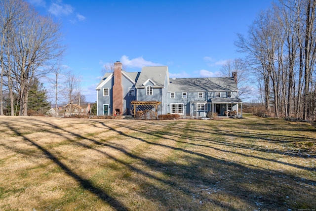 rear view of property with a lawn