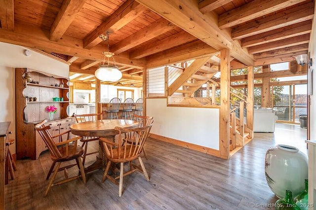 dining room featuring beamed ceiling, hardwood / wood-style flooring, and wood ceiling