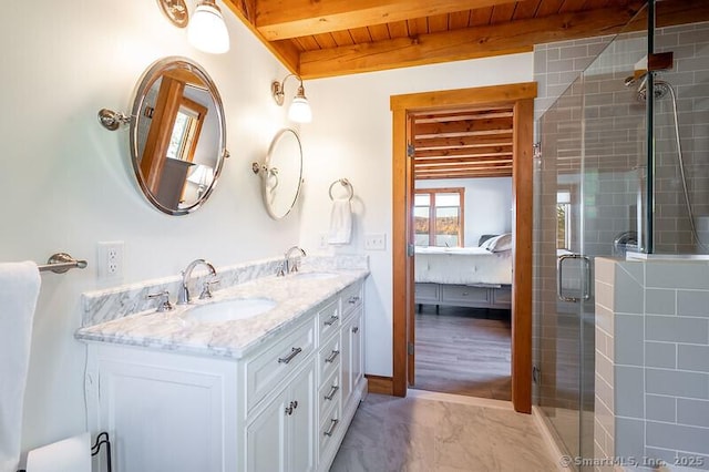 full bathroom with beamed ceiling, wooden ceiling, a sink, and connected bathroom