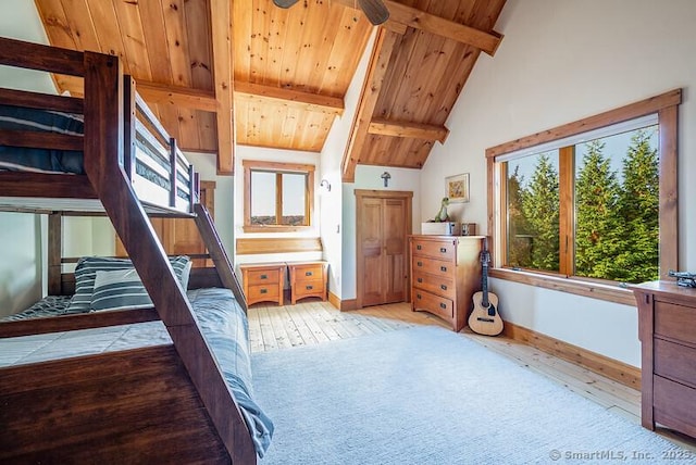 bedroom featuring beamed ceiling, wood ceiling, high vaulted ceiling, and light carpet