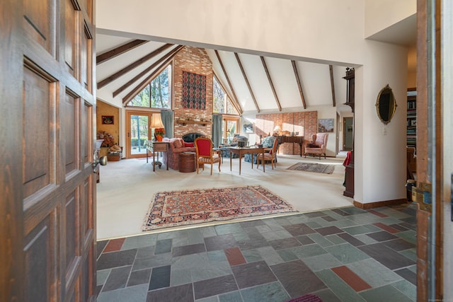 foyer with a brick fireplace, high vaulted ceiling, and beam ceiling