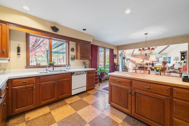 kitchen with decorative light fixtures, dishwasher, vaulted ceiling with beams, sink, and a chandelier