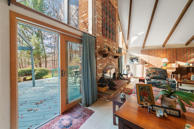 doorway with high vaulted ceiling, a brick fireplace, and beamed ceiling