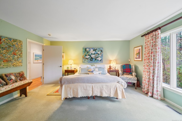 carpeted bedroom with multiple windows