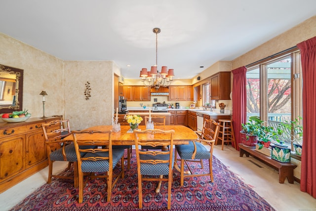 dining area with sink and an inviting chandelier