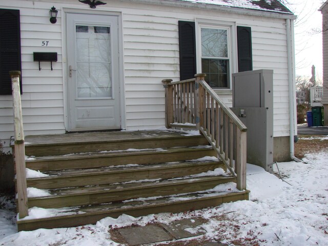 view of snow covered property entrance