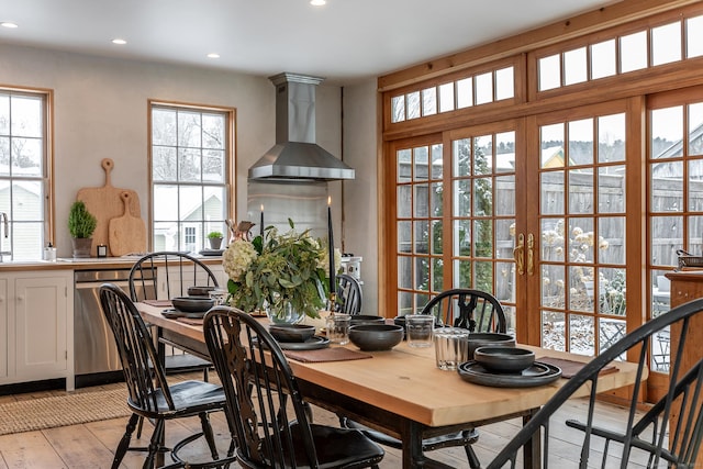 dining area with a healthy amount of sunlight, sink, and light hardwood / wood-style flooring