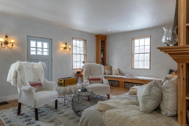 living room with wood-type flooring and a healthy amount of sunlight