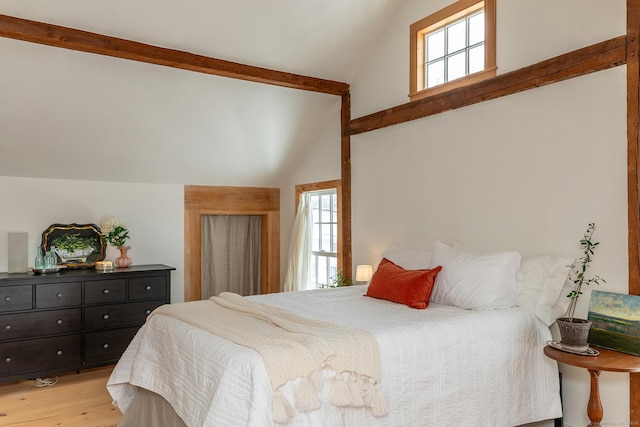 bedroom with lofted ceiling and light hardwood / wood-style floors