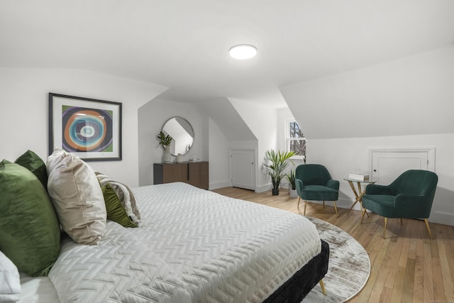 bedroom featuring vaulted ceiling and light hardwood / wood-style floors