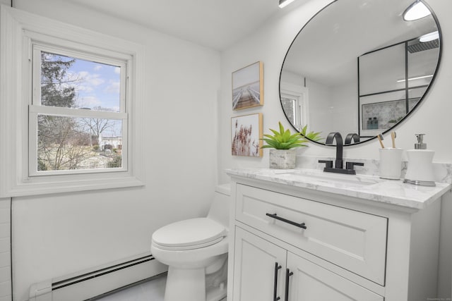 bathroom featuring baseboard heating, toilet, vanity, and tile patterned flooring