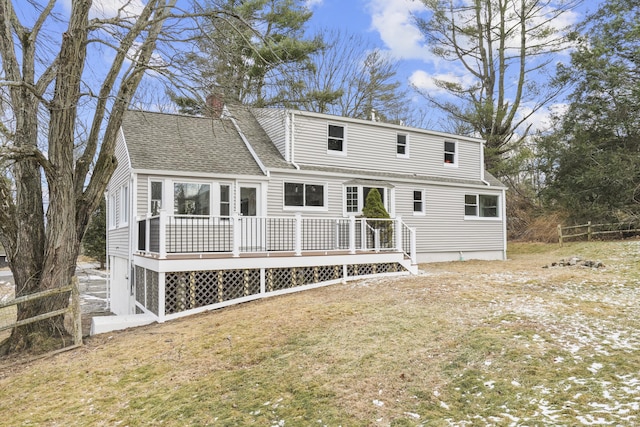 back of house with a lawn and a deck