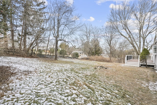 snowy yard with a deck