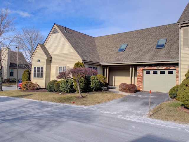 view of front of home with a front yard and a garage