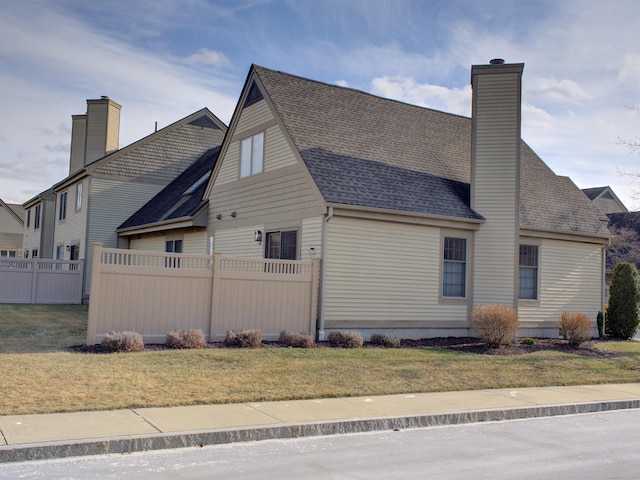 view of side of property with a lawn