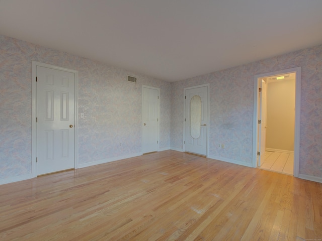 spare room featuring light hardwood / wood-style flooring