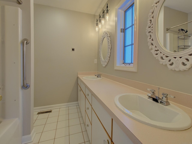 bathroom featuring a wealth of natural light, tile patterned floors, and vanity