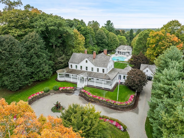 birds eye view of property with a wooded view