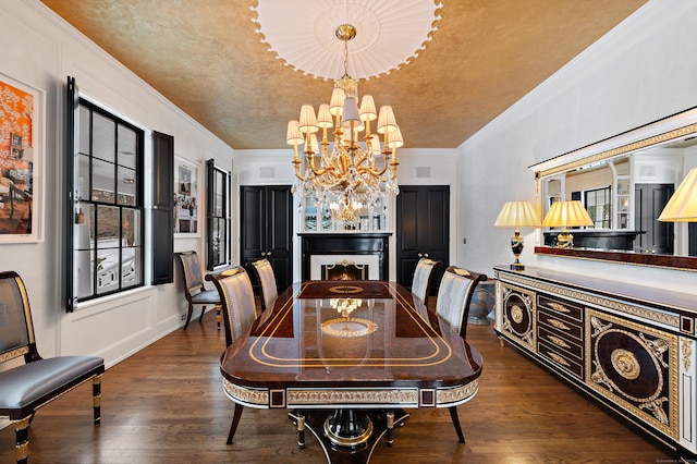 dining area with crown molding, wood finished floors, and a chandelier