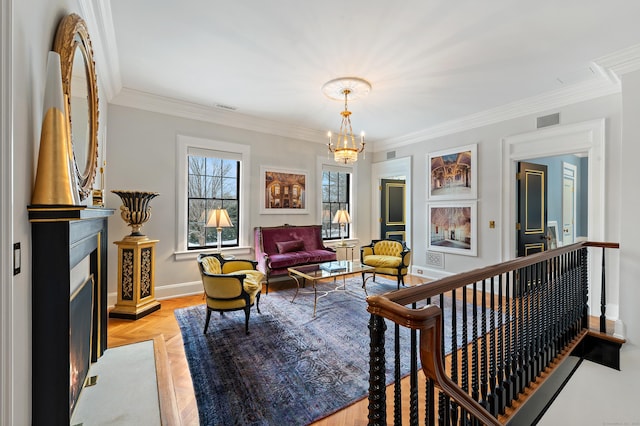 sitting room with visible vents, baseboards, crown molding, and a chandelier