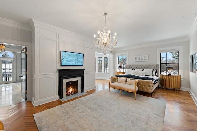 bedroom with a chandelier, multiple windows, and ornamental molding