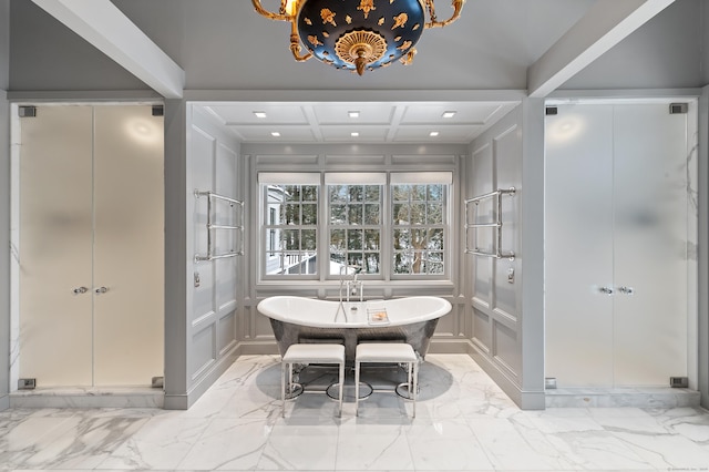 bathroom featuring a decorative wall, a stall shower, and marble finish floor