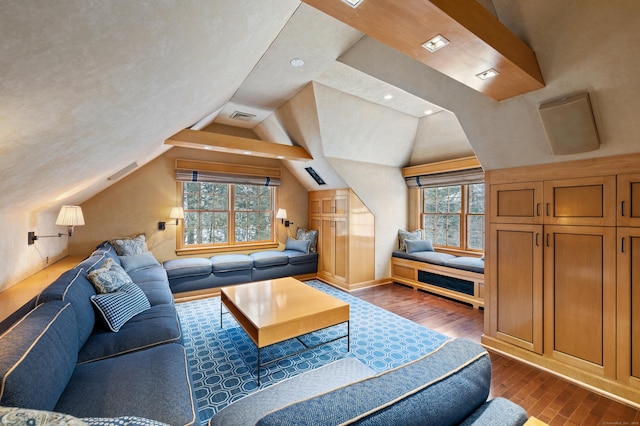 living room with vaulted ceiling, dark wood finished floors, and visible vents