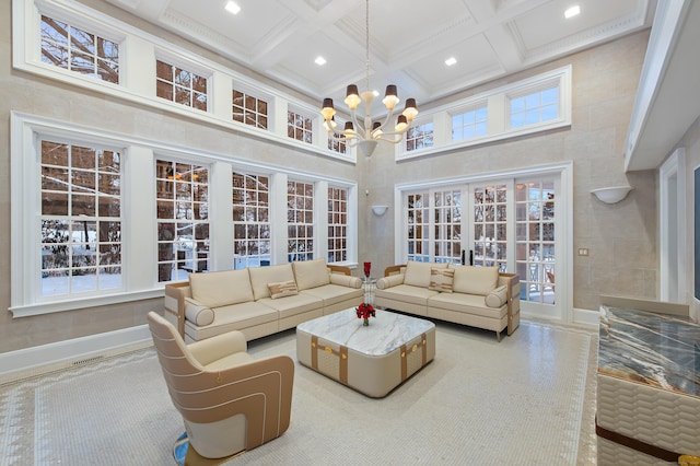living area with beam ceiling, a chandelier, recessed lighting, a towering ceiling, and coffered ceiling