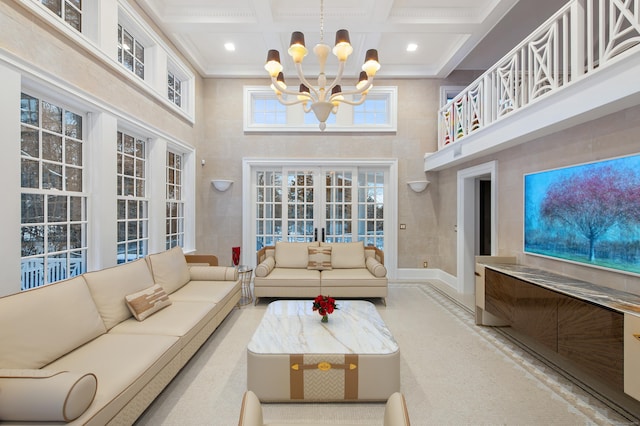 living room featuring ornamental molding, beamed ceiling, a high ceiling, coffered ceiling, and a notable chandelier