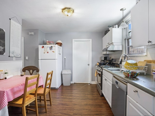 kitchen featuring decorative light fixtures, tasteful backsplash, white cabinetry, sink, and stainless steel appliances