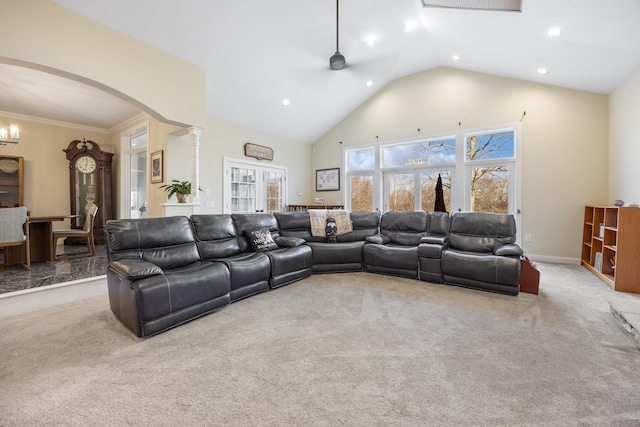 living room featuring light carpet, ceiling fan with notable chandelier, ornamental molding, and lofted ceiling