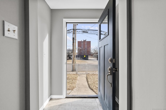 doorway featuring a healthy amount of sunlight and light tile patterned floors